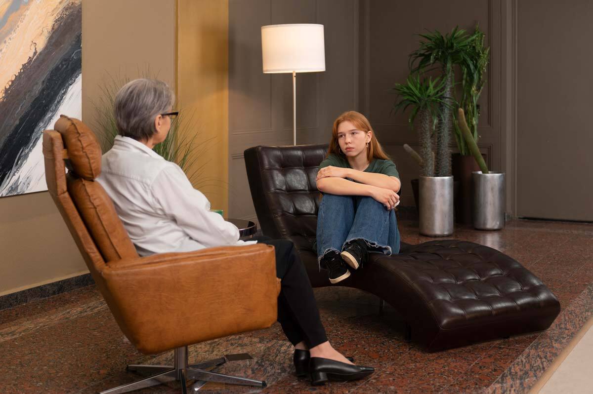 young woman speaking with therapist