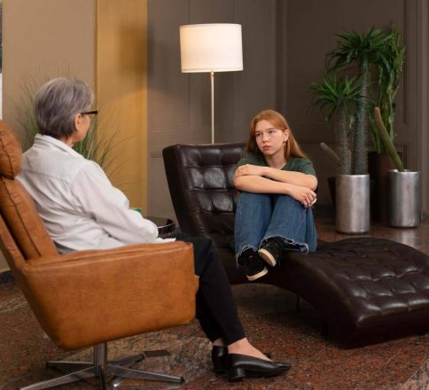 young woman speaking with therapist